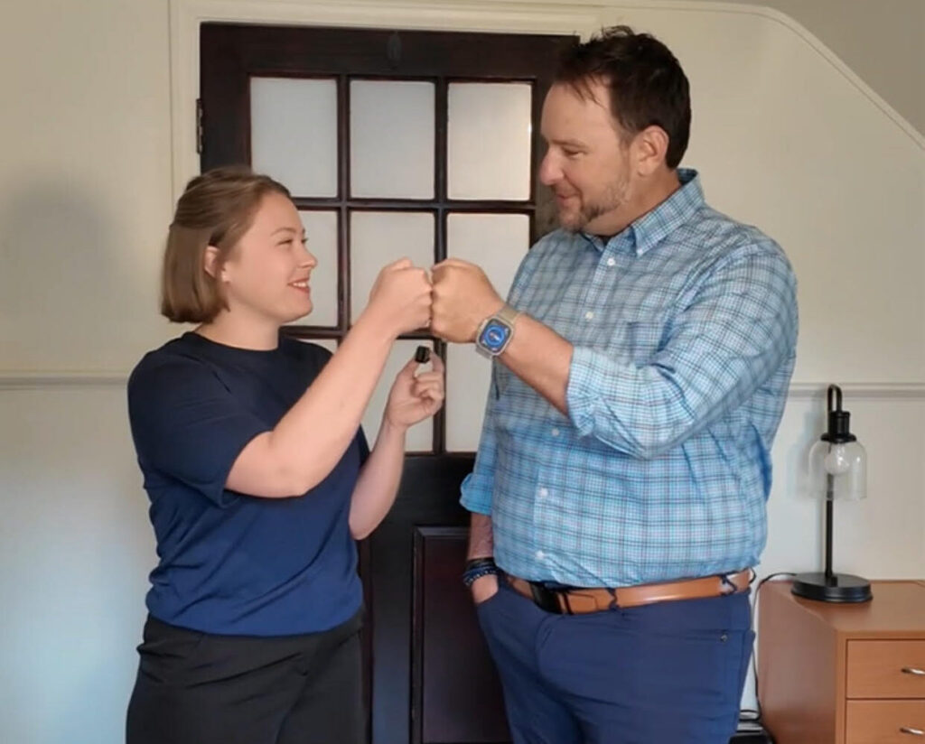 Rachel from Triangle Appraisal Group and Josh Oliver of Rhythmic Title fist-bump to mark their 24-hour title check partnership.